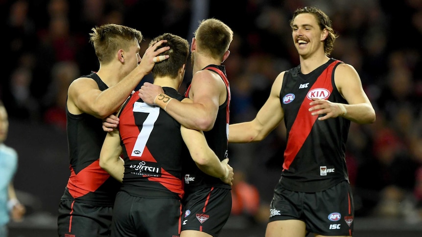 Bombers celebrate a goal from Zach Merrett against Fremantle at Docklands.