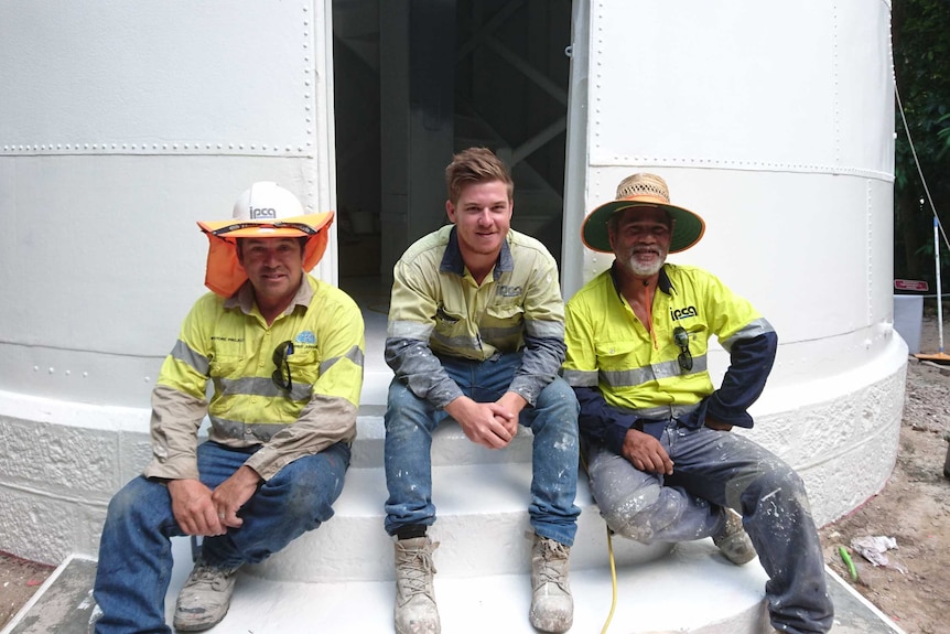 Portrait of three painters sitting on lighthouse steps