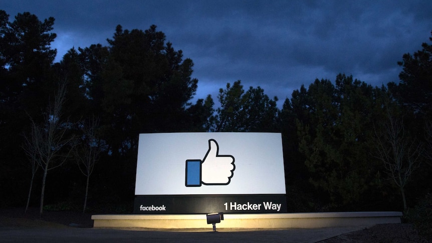 A lit sign is seen at the entrance to Facebook's corporate headquarters location in Menlo Park, California.