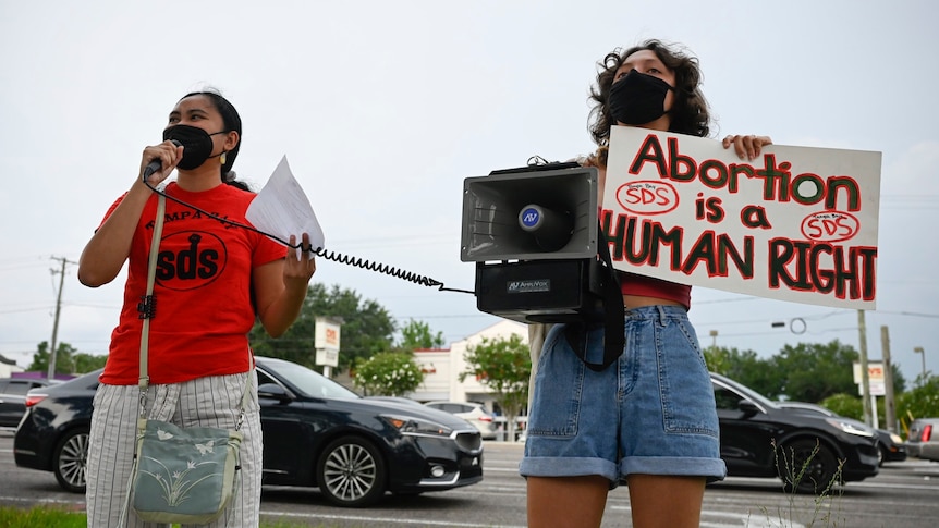 A pro-abortion protester speaks into a microphone