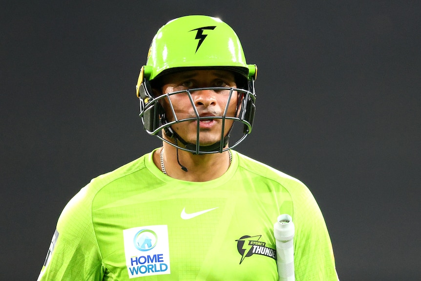 A close-up photo of Sydney Thunder player Usman Khawaja walking off the field after getting out in the Big Bash League.