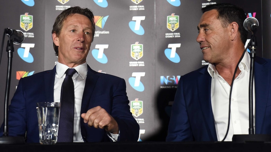 Melbourne Storm coach Craig Bellamy (L) talks to Cronulla coach Shane Flanagan at grand final event.