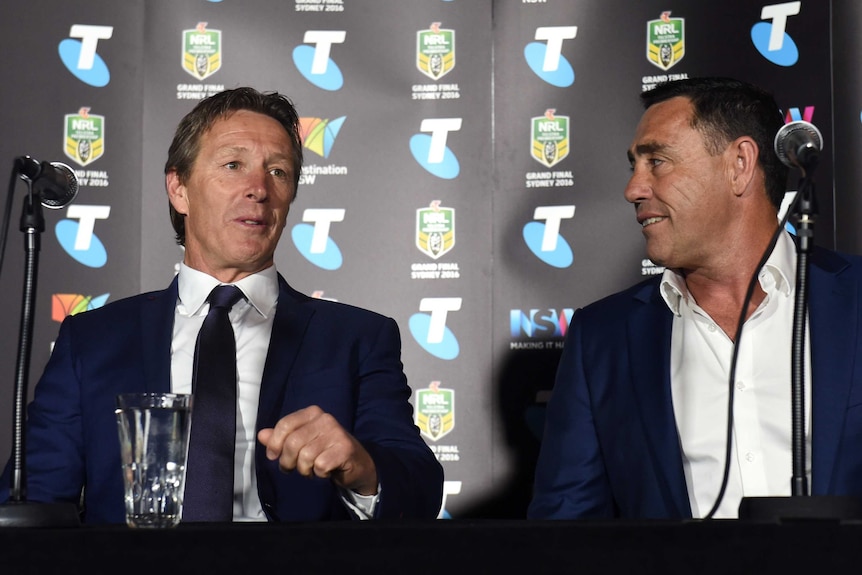 Melbourne Storm coach Craig Bellamy (L) talks to Cronulla coach Shane Flanagan at grand final event.