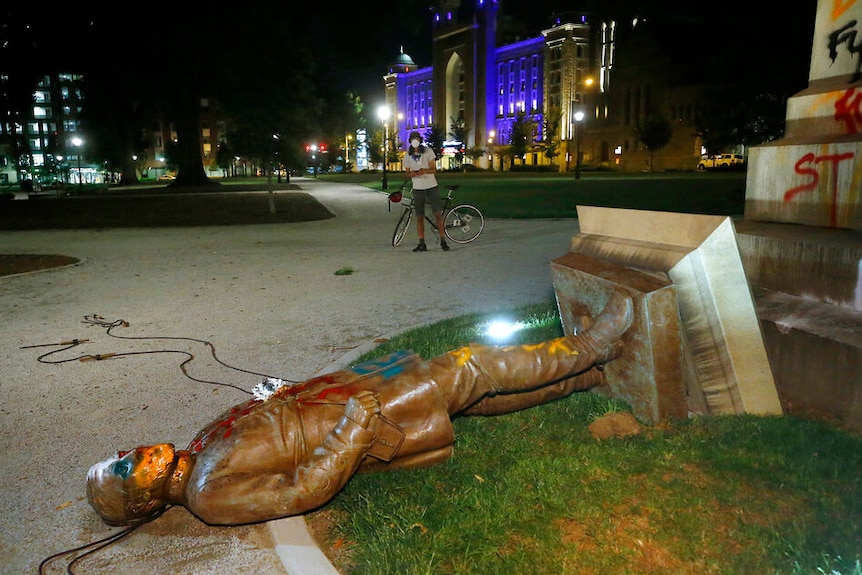 The statue of Confederate Gen. Williams Carter Wickham lies on the ground