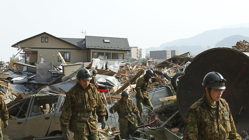 Japanese soldiers search for victims