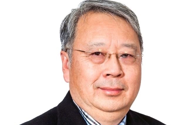 A portrait of Sam Wong against a white background.