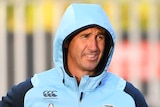 Andrew Johns in a Blues tracksuit holds a rugby ball at NSW Origin training