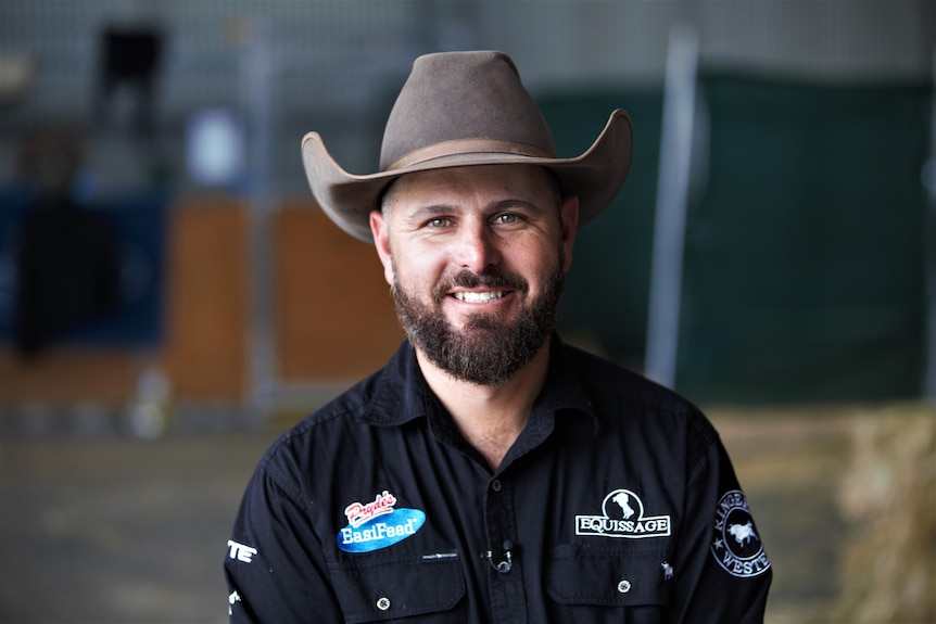 Photo of a man smiling with a cowboy hat.