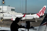 a virgin airlines plane on the tarmac at sydney airport
