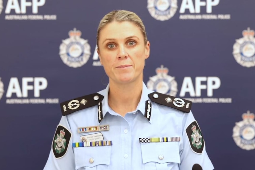 A police woman in front of a backdrop with AFP written on it. 
