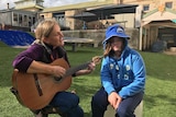 12 year old Shelby listens to her teacher playing the guitar at Giant Steps school in Sydney