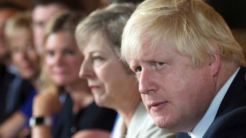 Boris Johnson sits next to Theresa May during a cabinet meeting.
