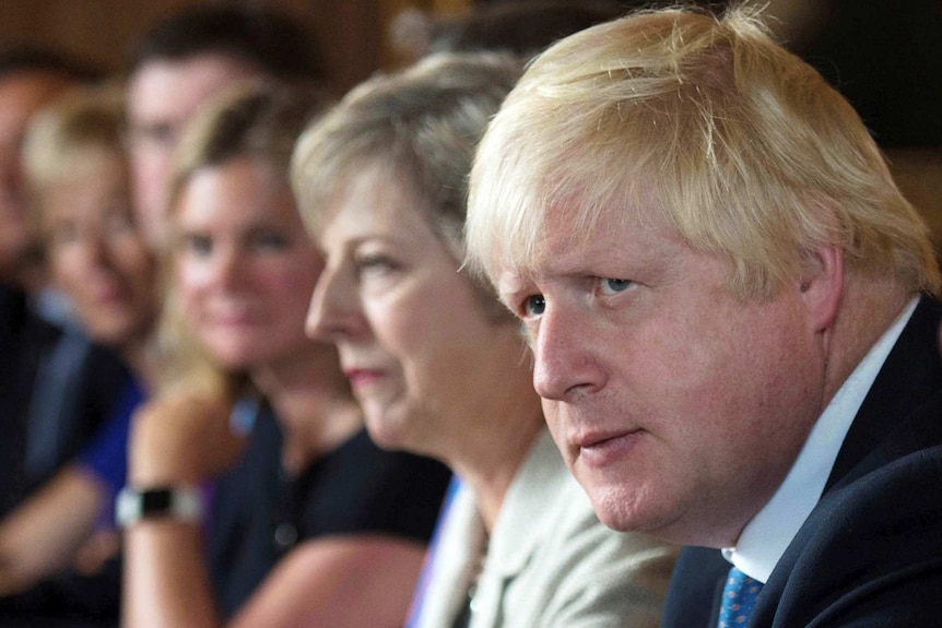 Boris Johnson sits next to Theresa May during a cabinet meeting.