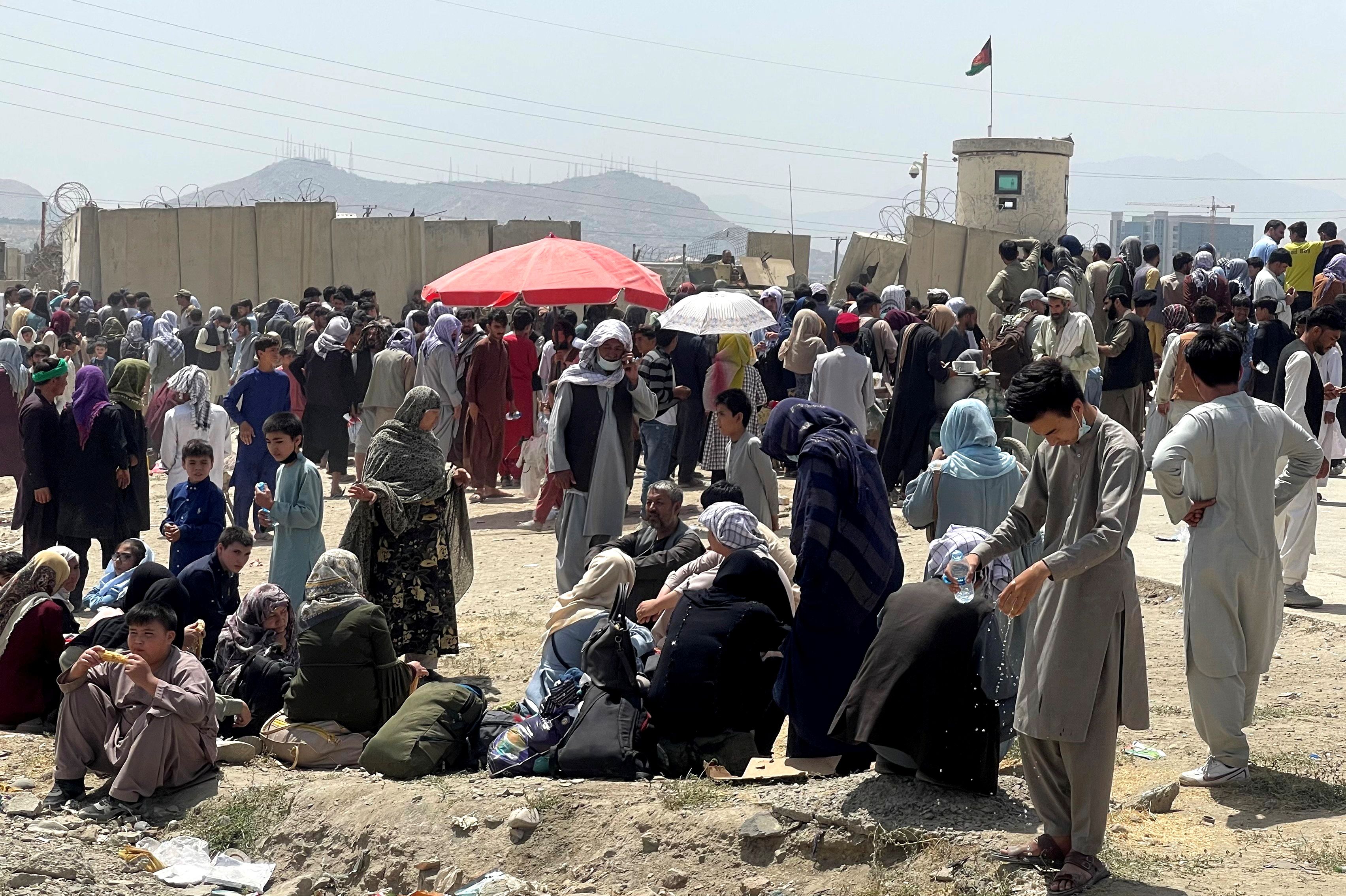 Afghans throng outside Kabul's international airport as they try to flee Taliban rule