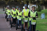 A group of people riding segways on a pathway in Perth's CBD.