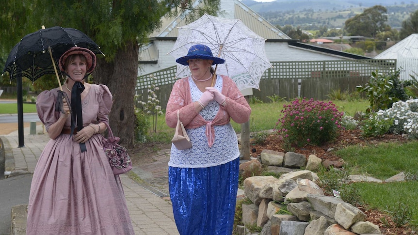Jenette Alones and Elizabeth Hall make their way into Richmond village ahead of the royal visit's Tasmanian leg.