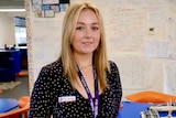 Young teacher Brittany Herrington standing in a colourful Year 5 classroom.