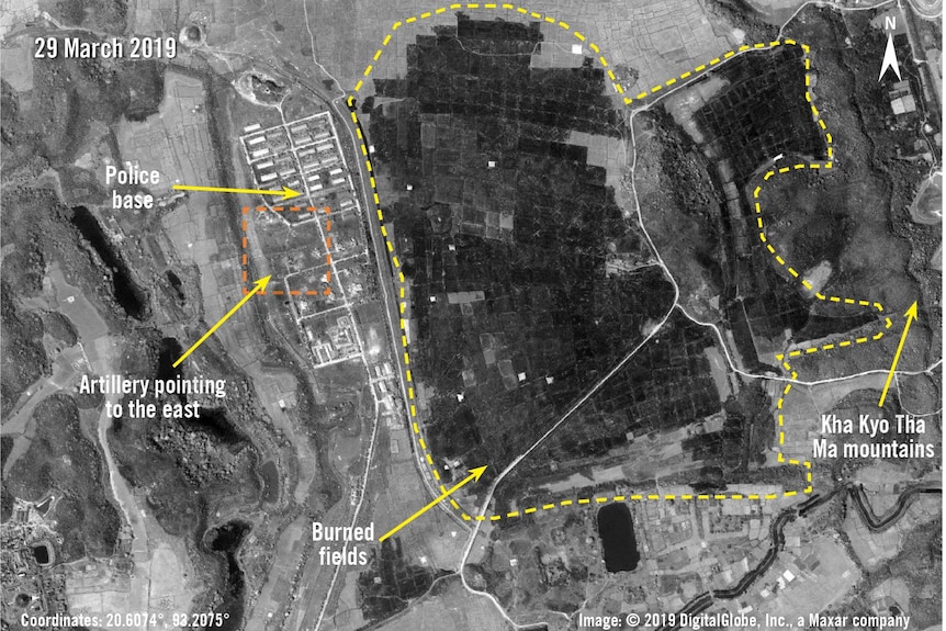 An aerial view shows burnt areas and military buildings.