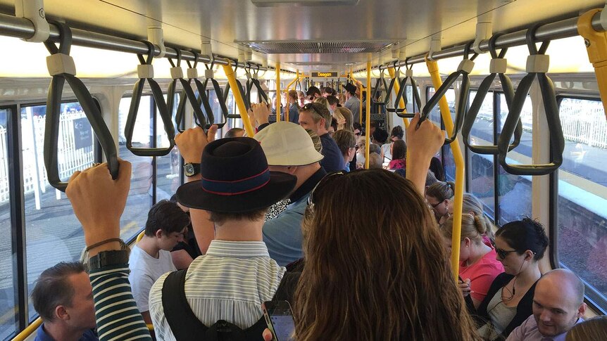 Commuters aboard a packed delayed train bound for Brisbane's CBD from Deagon station