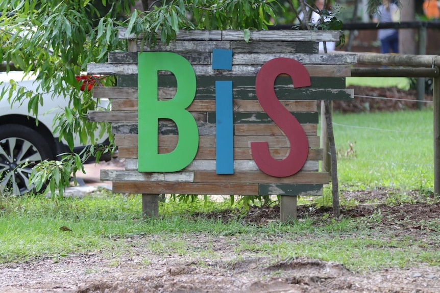 A green, red and blue sign spells out the letters B I S. 
