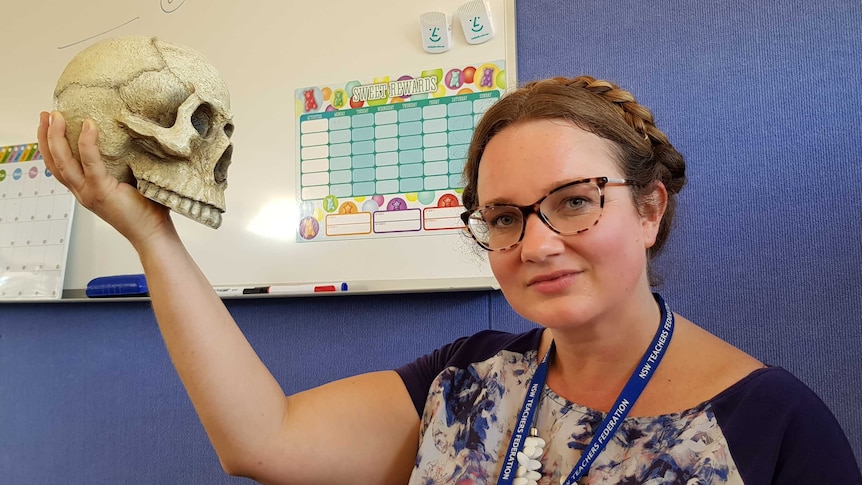 A woman holds a skull