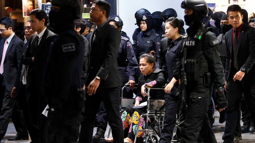 Indonesian Siti Aisyah is escorted as she revisits the Kuala Lumpur International Airport.