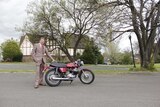 Terry King standing next to his motorbike