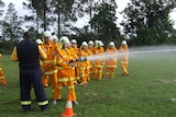 Students in full firefighter uniform using the high pressure hose during drills on the Macksville Highschool oval.