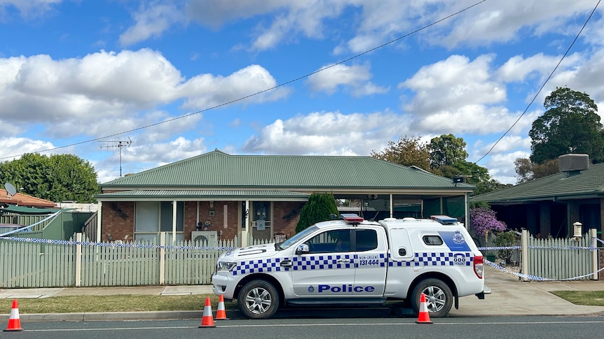 A police car sits parked out the front of an address where a woman was found deceased.