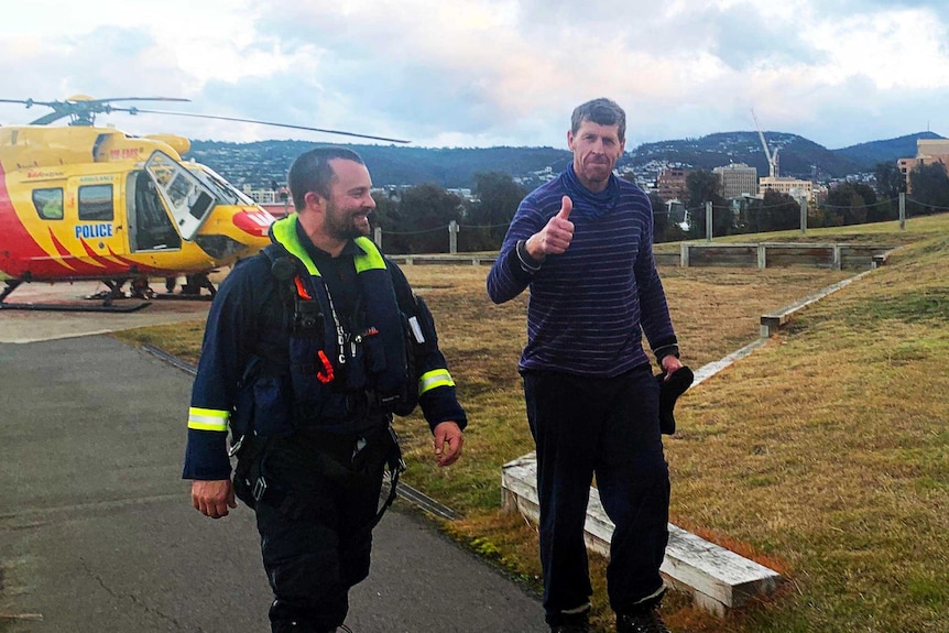 Michael Bowman gives a thumbs up after arriving in Hobart.