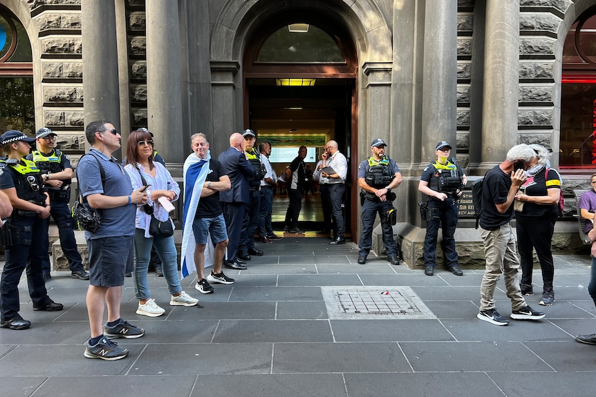Police and protesters outside the Melbourne City Council building.