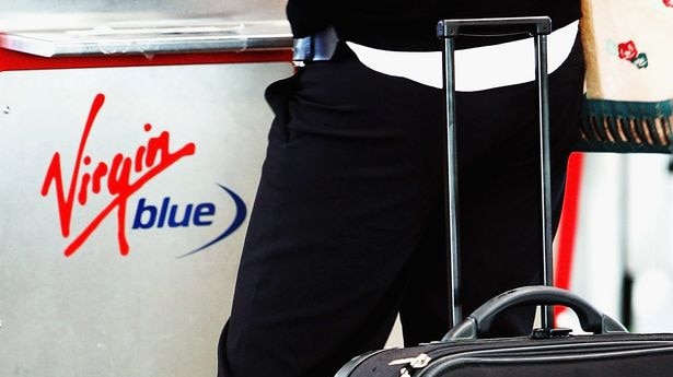 A woman uses a Virgin Blue self check-in terminal at Mascot airport