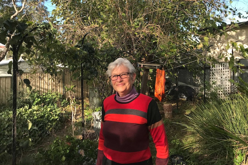 Annie Marlow from the Hooka Creek Bushcare Group stands in her backyard