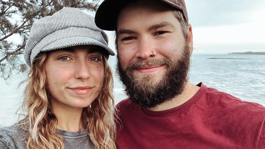 Tash and her husband smile for a selfie in front of the ocean, for story about whether vaping can help quit smoking.