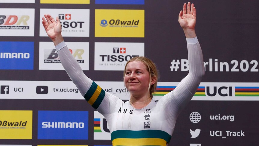 An Australian female track cyclist waves to the crowd after winning a bronze medal at the world championships in Berlin.
