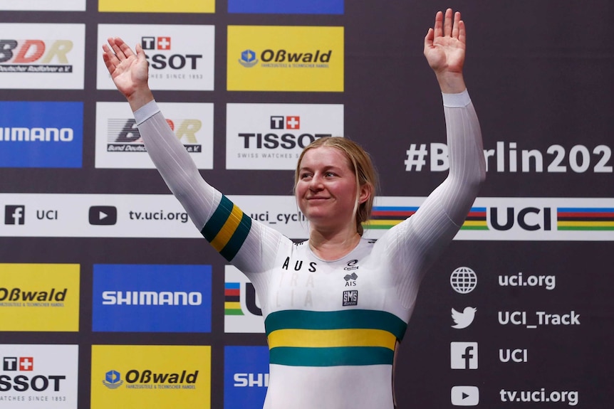 An Australian female track cyclist waves to the crowd after winning a bronze medal at the world championships in Berlin.