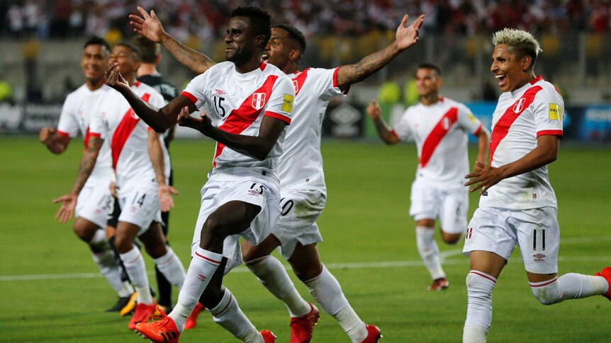 Christian Ramos and his Peru teammates run to the sideline to celebrate a goal against New Zealand.