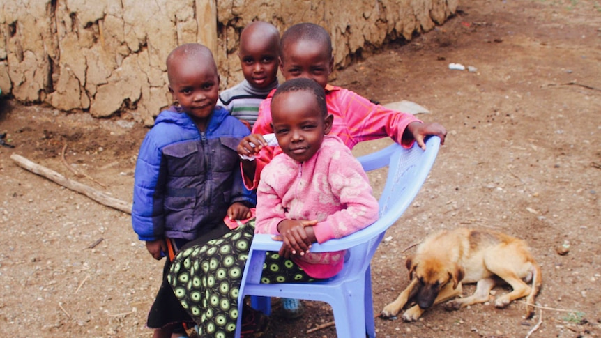Four young Kenyan children pose for the camera.
