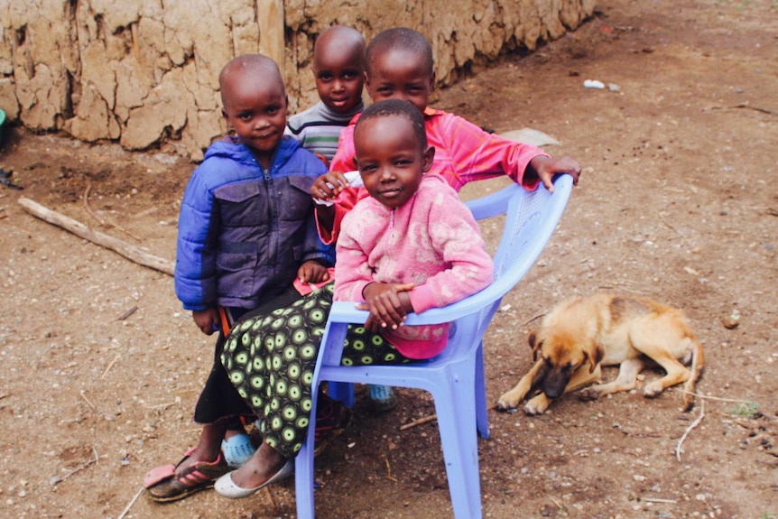 Four young Kenyan children pose for the camera.