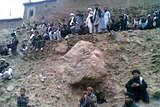 Crowd watches the execution of a woman in Afghanistan