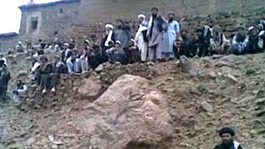 Crowd watches the execution of a woman in Afghanistan