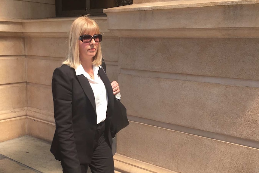 Lynne Cowan leaves court after giving evidence.