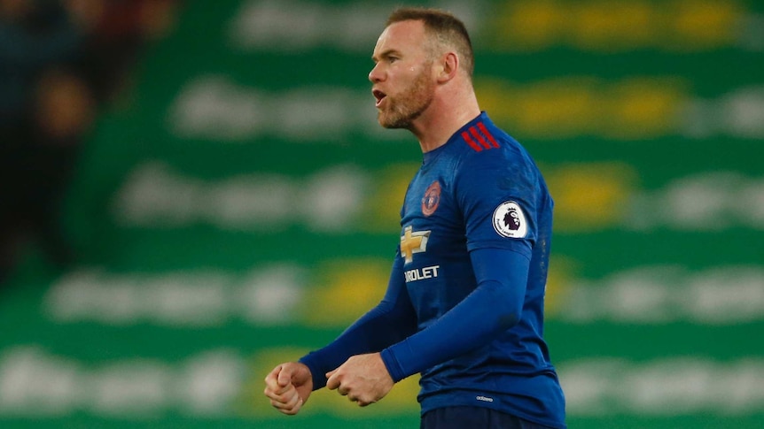 Wayne Rooney celebrates breaking Manchester United's goal-scoring record