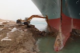 A backhoe is trying to dig out a giant ship that has run aground, the ship is approx 5x as big as the backhoe