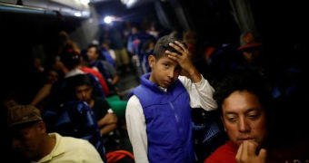 Migrant make their way to a US border in a bus.