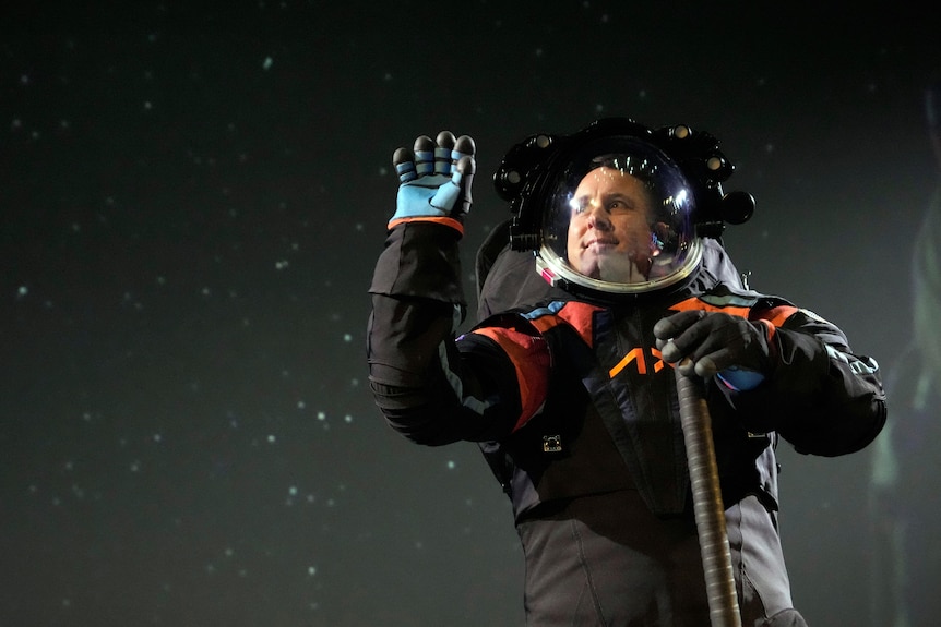 A man in a black and orange moon suit. 