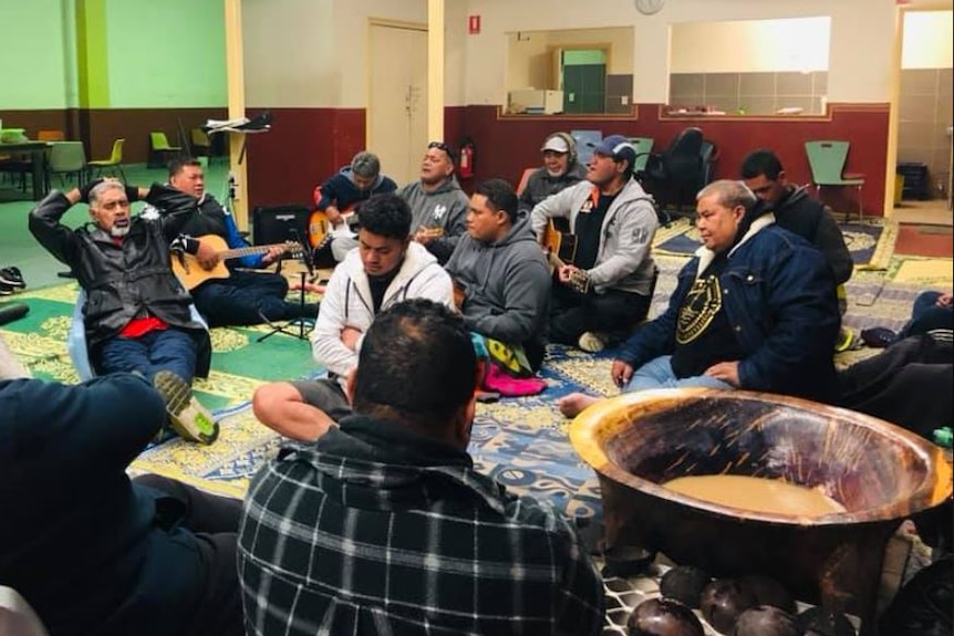 Several Tongan members of the Fofo'anaga Club in Sydney sing and drink kava.