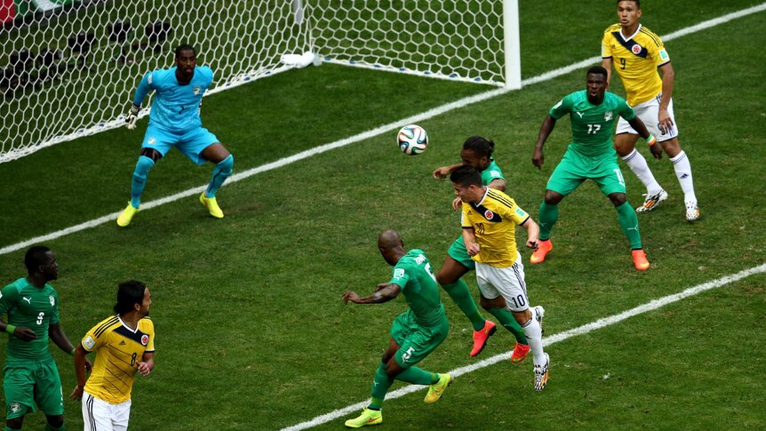 Colombia's James Rodriguez heads the opening goal against Ivory Coast at the World Cup.