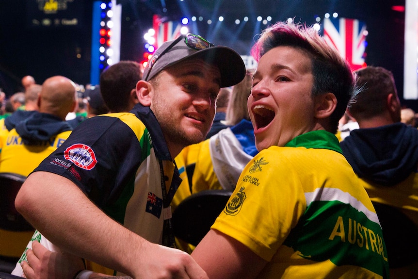 A young man looking at a young woman who is very excited