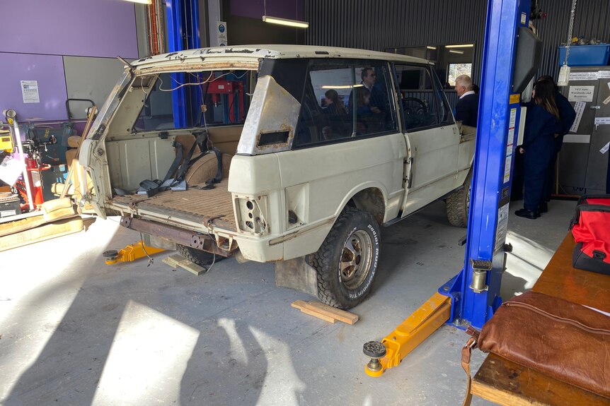 An old car which has been stripped. 